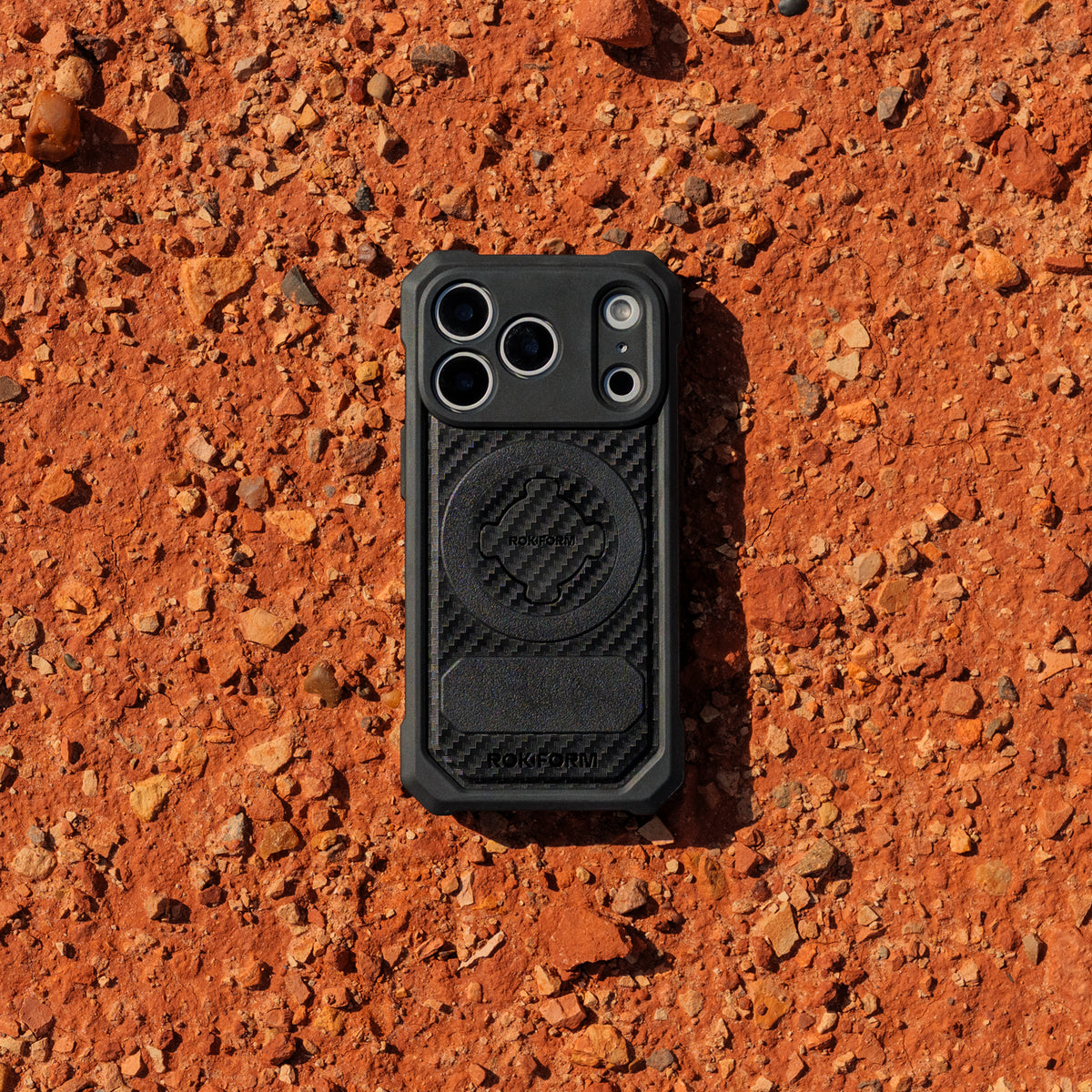 iPhone 18 Rugged case on orange dirt.