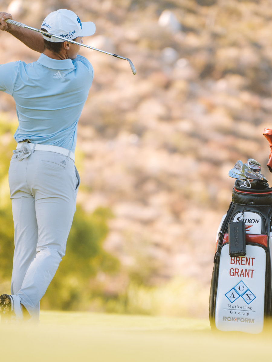 Professional golfer Brent Grant next to golf bag with ROKFORM G-ROK Wireless Golf Speaker attached to golf bag
