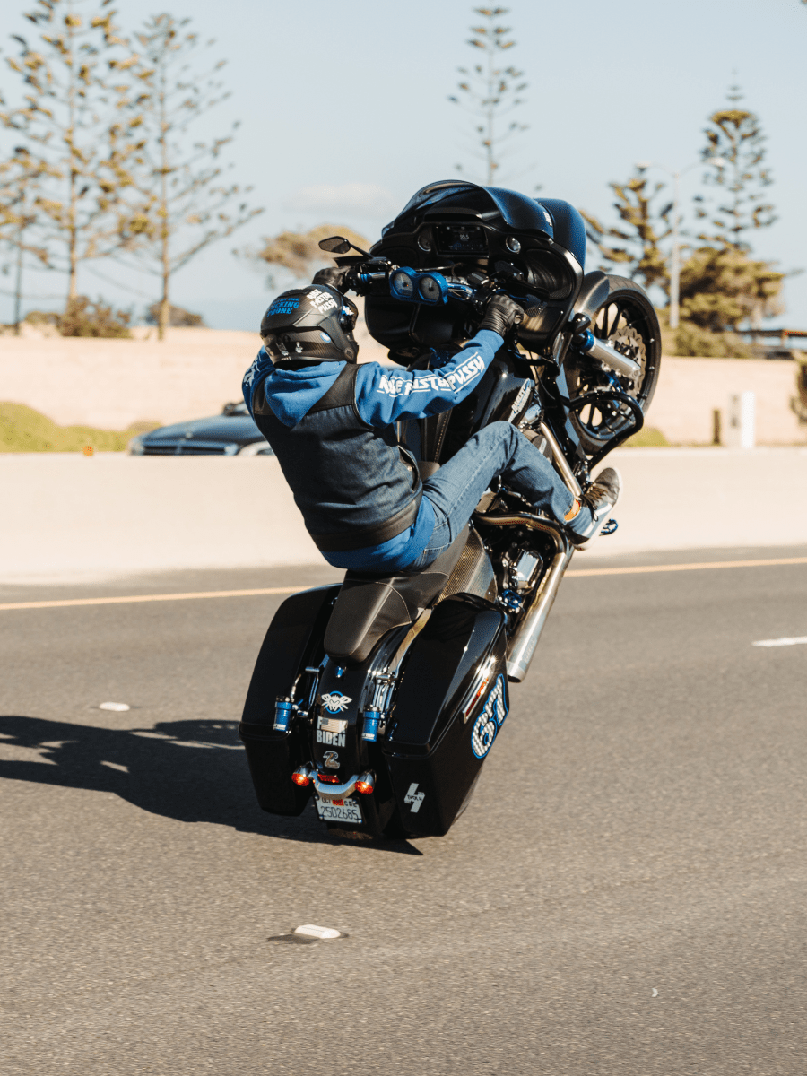 How to wheelie a motorcycle: From Physics to Freestyle