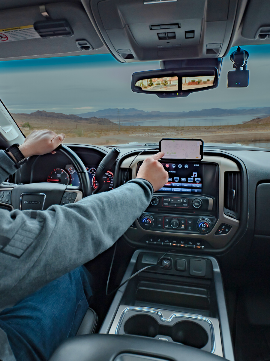 Man using GPS with Rokform phone holder for trucks