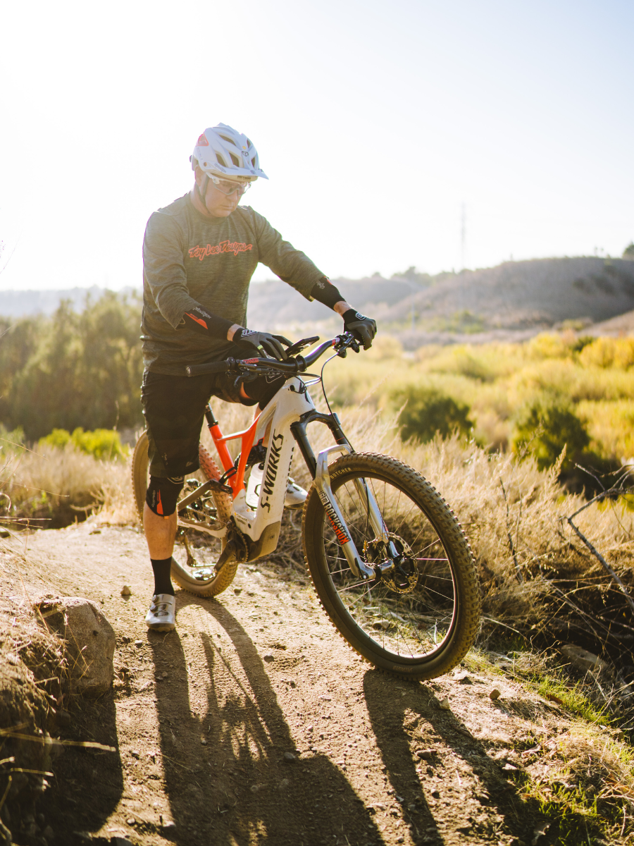 Man riding mountain bike with ROKFORM bicycle phone mount