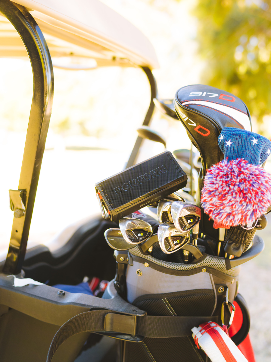ROKFORM G-ROK Wireless Golf Speaker attached to golf clubs on golf cart