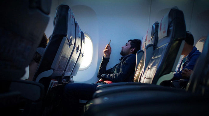 Stiff neck, long flights - don’t be this guy on your next trip. Grab a portable phone mount that keeps your phone out‑in‑front so you can stream, scroll, and relax without holding it the whole time