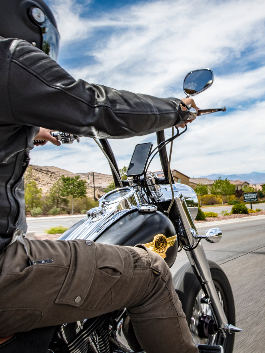 Man riding motorcycle with ROKFORM motorcycle phone mount