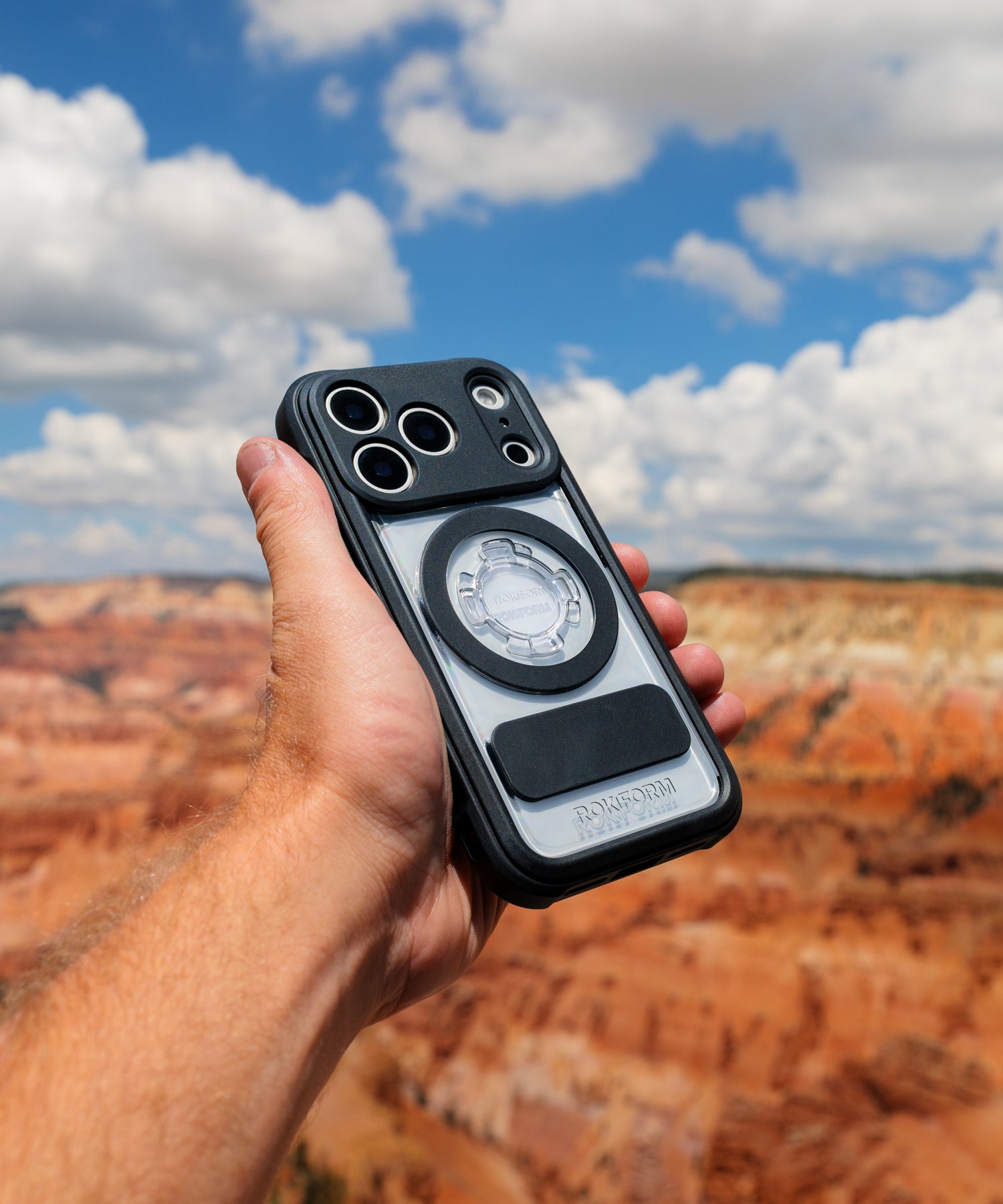 Rokform Crystal Case held in hand against orange desert hills