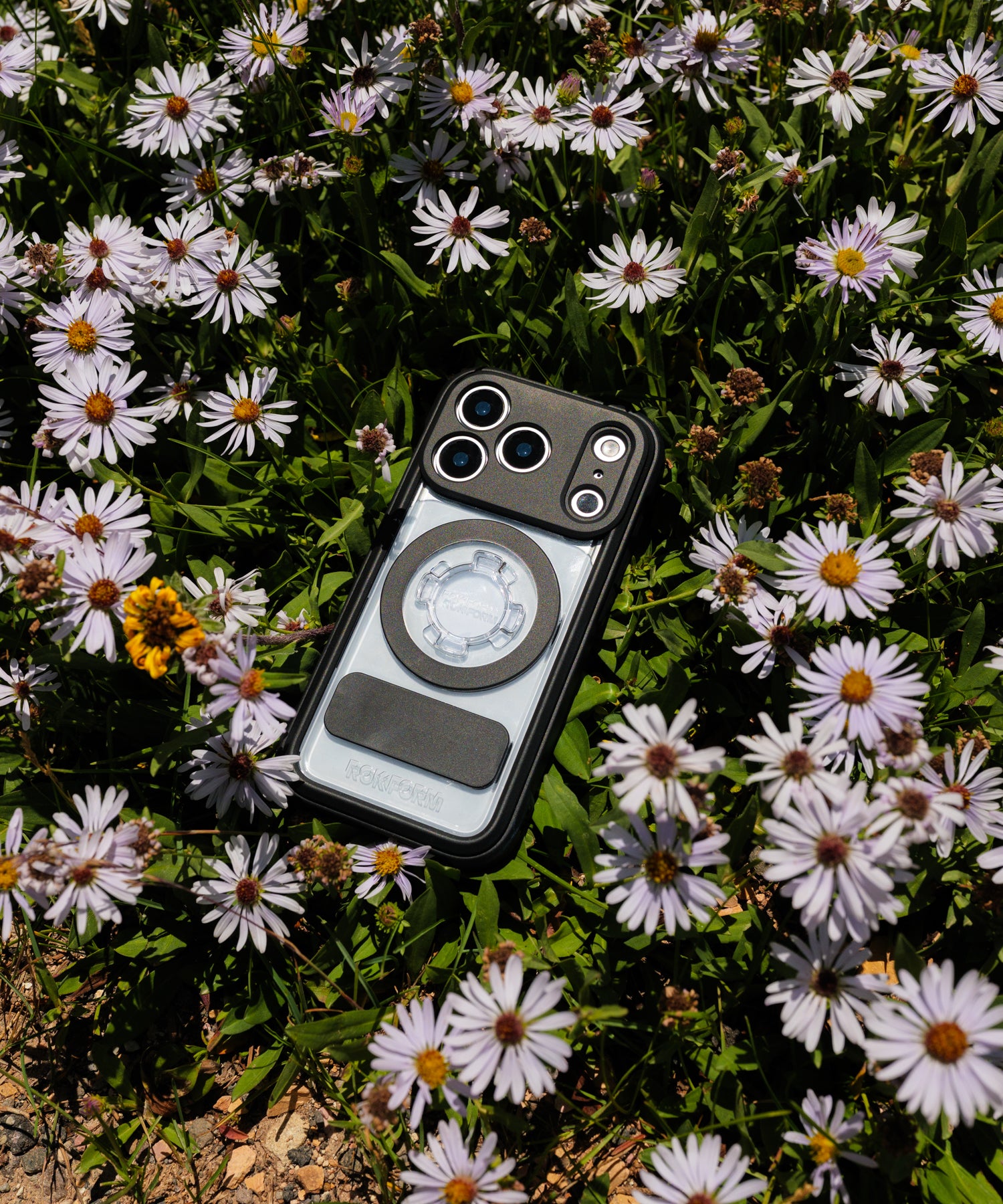 Rokform Crystal Case for iPhone set in a bed of wildflowers