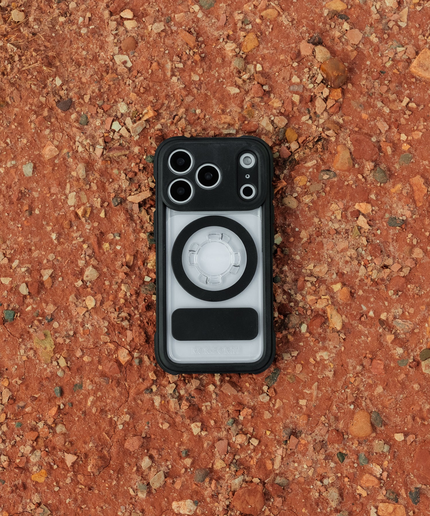 Rokform Crystal Case for iPhone resting on red desert dirt