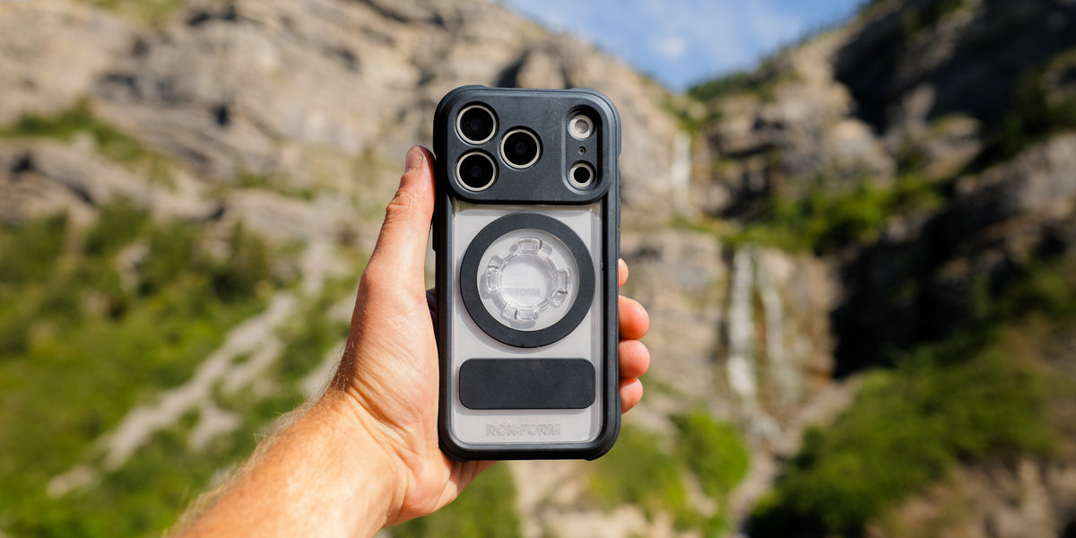 Rokform Crystal Case held up with mountains in the background