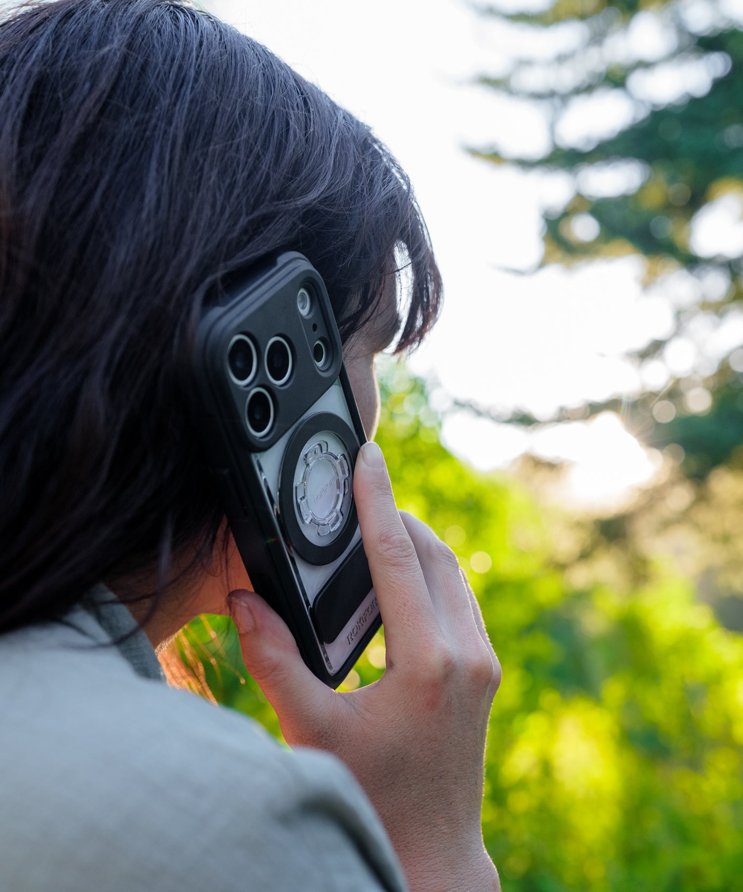 Woman talking on an iPhone in a Rokform Crystal Case